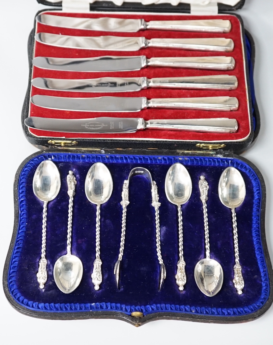 A cased set of six late Victorian silver apostle teaspoons and tongs, Sheffield 1900, 116 grams, and a set of six George VI silver handled cake knives, Sheffield 1957